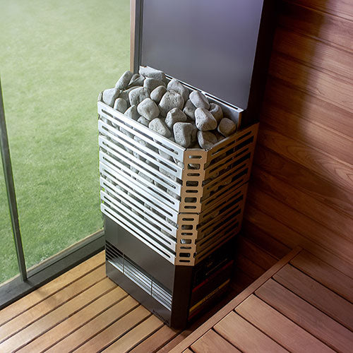 Saunum Air 5 stainless steel heater with AirIQ control installed in light wood sauna room showing patented climate equalizer